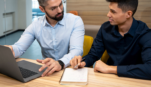 Infoglen Careers: Experienced leaders mentoring a team member over a laptop to guide their professional journey.